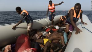 File: remains of dead immigrants rescued off Libyan coast: 100 more immigrants drown in Libya Coast