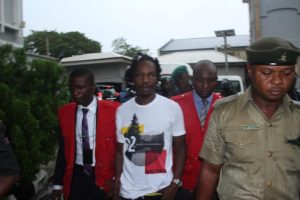 file photo: Naira Marley in court with EFCC operatives