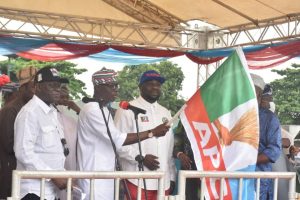 Governor Babajide Sanwo-Olu handing over flags to Lagos APC chairmanship candidates at the official presentation of party’s flags ahead of the July 24 Local Government election in Lagos.