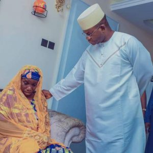 Governor Yahaya Bello consoling Martha Ode Aminu, one of the wives of his late outrider, Inspector Aminu Salihu, during the visit.