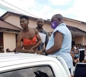 Wori Onyekachi Miracle apprehended for sneaking into female hostel disguised a woman being paraded at the University campus