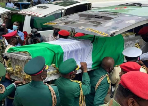 The remains of one of the dead officers being brought out of ambulance