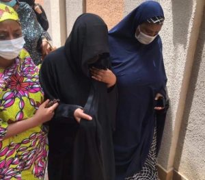 Fati, wife of the late COS supported by sympahthisers during funeral service for her husband at the National Mosque