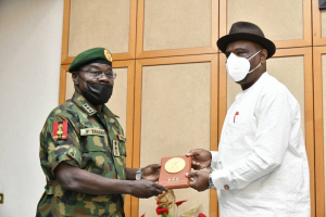 Governor of Rivers State, Nyesom Ezenwo Wike (rights) receives a plaque from the Chief of Army Staff, Lt. General Farouk Yahaya during the latter's courtesy call at the Government House, Port Harcourt on Monday.