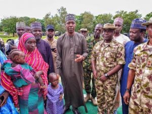 Left: Hassana Adamu and her two children being handed over to Governor Babagana Zulum in Gwoza on Saturday