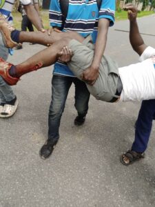 Some protesting Julius Berger workers rescuing an injured Colleague allegedly shot by Police in Bori, Khana Local Govt.