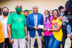 Onyema presenting the cheque to members of the 1999 Falcons