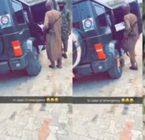 Still from the video purportedly showing Minister of Defence entering a vehicle with a gun slung over his shoulder