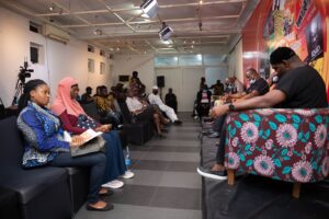 Writer and poet, Toni Kan while reviewing RMD's potrait of a Warri boy at the 2021 edition of Lagos Arts and Books Festival in Lagos, recently.