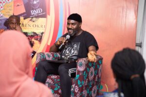 Writer and poet, Toni Kan while reviewing RMD's potrait of a Warri boy at the 2021 edition of Lagos Arts and Books Festival in Lagos, recently.