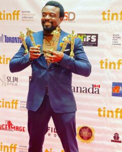 Odigie with the awards he won at the Toronto international Nollywood Film Festival