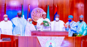 President Buhari with the Electoral Bill he signed into law
