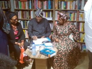 Dr Yemi Ogunbiyi autographing his memoirs. To his left is Mrs Aderonke Fetuga