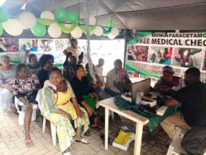 Staff of Dexa Medical conducting malaria test on some of the beneficiaries of the free health care initiative