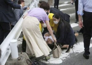 Former Japanese prime minister Shinzo Abe lies on the ground after apparent shooting during an election campaign for the July 10, 2022 Upper House election, in Nara, western Japan July 8, 2022. in this photo taken by Kyodo. Mandatory credit Kyodo via REUTERS.