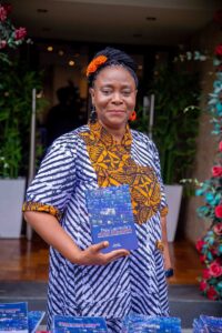 Professor Peju Layiwola poses with her book, Indigo Reimagined