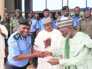 Governor Namadi handing over the keys of the motorcycles to the DC ops, Jigawa Police Command