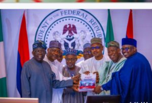 President Tinubu, left, receiving report from the National Conference on Livestock Reforms and Mitigation of Associated Conflicts in Nigeria.