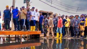 Lagos State Governor, Mr. Babajide Sanwo-Olu (second left) being shown a spot during his assessment tour of the flooded areas in Lagos Island on Sunday, 8 October 2023