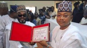 Usman receiving his Certificates of return