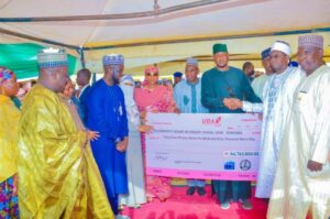 Governor Radda disbursing a cheque to one of the schools' management