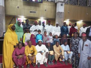 Governor Yusuf, CP Gumel in a group photograph with the rescued children and their parents at Kano Government House