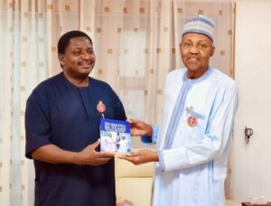Femi Adesina presenting a copy of his book to former President Buhari