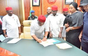 Governor Hope Uzodimma (middle) signs the Imo 2024 Budget into law, watched from left, the Deputy Governor, Prof. Placid Njoku, the Speaker, Rt. Hon Chike Olemgbe (second right) and the Clerk of the Assembly, Barr Chinelo Emeghara