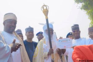 Gov Bello presenting the staff of Office to one of the traditional rulers