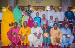 Group photograph of the rescued children, their parents, Governor Yusuf, CP Gumel, among others during the official handing over of the children their parents