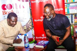 Femi Adesina autographing his book