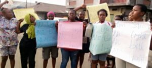Some married women protesting lack of power supply causing their husbands to starve them of conjugal duties at night due to heat.