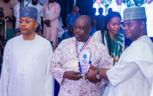 Richard Elesho receiving the star prize from Governor Yahaya Bello, right