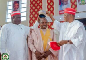 NNPP state Chairman and Governor Yusuf crowning one of the defected Council chairmen with the Kwankwasiyya cap at Coronation Hall, Government House, on Saturday