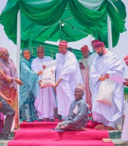 L-R: Managing Director and Chief Executive of the Aliko Dangote Foundation, Zouera Youssoufou, Group Executive Director, Commercial Operations, Dangote Industries Limited (DIL), Fatima Aliko Dangote, President, Dangote Group, Aliko Dangote and the Governor of Kano State, Alhaji Abba Kabir Yusuf, presenting a bag of 10kg rice to one of the beneficiaries at the flag-off ceremony of Aliko Dangote Foundation’s (ADF), Food Intervention Programme, which was launched in Kano on Saturday
