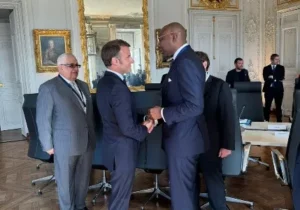 Aigboje Aig-Imoukhuede having a handshake and a tête-à-tête with President Macron at the Council’s meeting with the President, and Gilbert Chagoury looking on