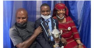 Slvester Oromoni (Jnr) and his parents at a school event