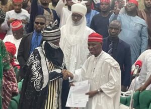 Khalifa Muhammad Sanusi 11 receiving his letter of reinstatement,Governor Kabir Yusuf