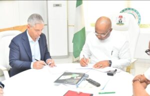 Governor Hope Uzodimma (right) and Managing Director of Hassan Allam Construction, Mahmoud El Essawy sign the dotted lines to seal deal on the building of a Five Star hotel in Owerri under a Public Private Partnership arrangement at Government House Owerri... Thursday