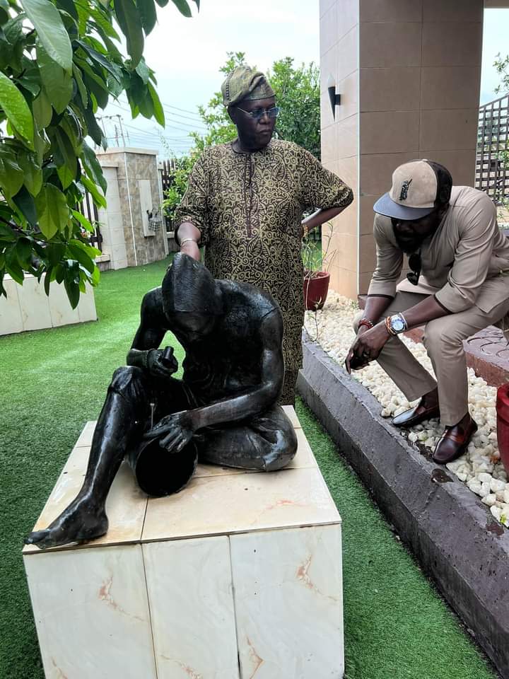 Omooba Shyllon and one of his artwork collections