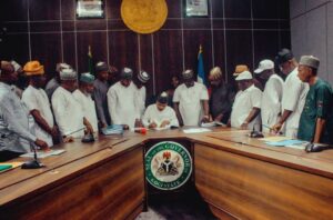 Governor Ododo signing the bills into law