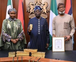 Minister of Solid Minerals Development, Dr. Dele Alake presenting the gold bar document to President Bola Tinubu at the State House, Abuja recently. With them is the Executive Secretary, Solid Minerals Development Fund, Mrs Fatimah Shinkafi.