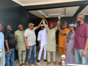 Ademola Bello's hands raised by supporters
