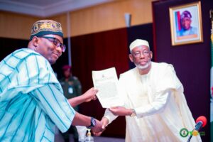 Governor Namadi handing over the letter of appointment to Dr. Musa as the new Commissioner for the Ministry of Power and Renewable Energy.jpg