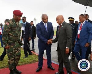 Liberian President Boakai being welcomed by the Deputy Defence Minister, Dr Augustine Lamin at the Barclay Military Training Center in Monrovia.jpg