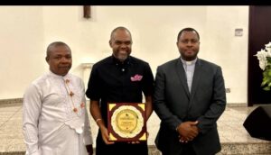 Mayor of Housing ,My ACE -China ,CEO of the Housing and Construction Mayor Ltd, holding a plague awarded to him by the Navy School,Port Harcourt