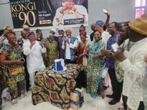 .Prof Wole Soyinka flanked by family and former students during the cutting of the birthday cake.jpg