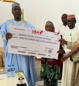 Dantiye presenting the cheque to Governor Zulum.jpg