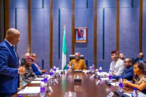 President Bola Tinubu, centre, Olawale Edun (standing), Governor Babajide sanwo-Olu of Lagos and others during a meeting with Nigerians in China.jpg