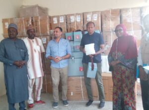 Rahama displaying the irems with Hajiya Sa'adatu and other officials.jpg